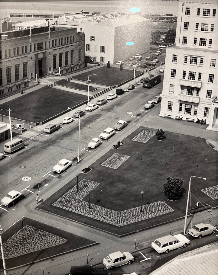 Historic black-and-white photograph showing much more open green space around Civic Square